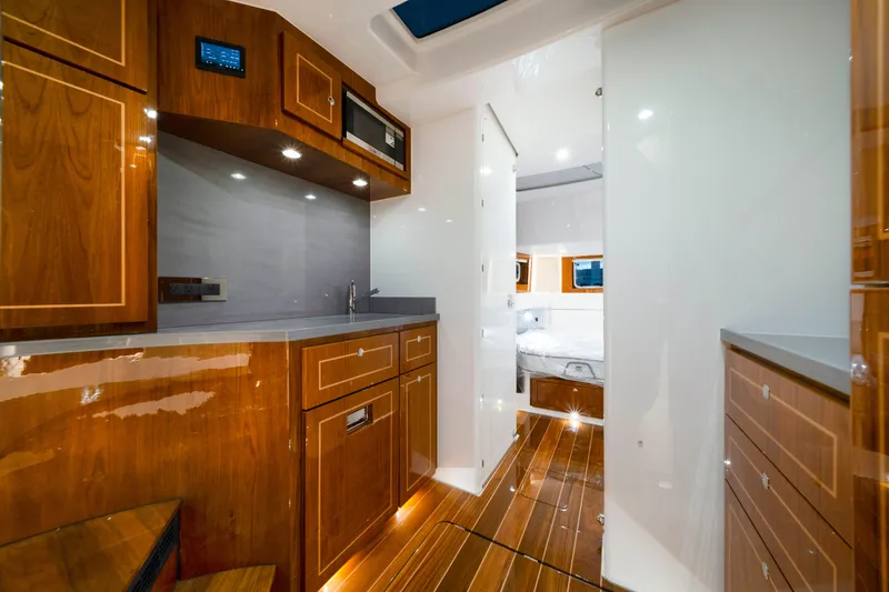 Slide: The Image of Luxurious interior of 2027 HCB 56 Suenos yacht with wood cabinetry and modern amenities. - 59
