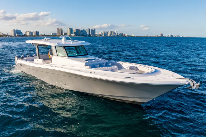 Slide: The Image of 2027 HCB 56 Suenos luxury yacht cruising on open water near city skyline. - 6