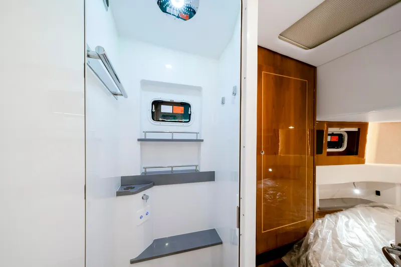 Slide: The Image of Luxurious interior of 2027 HCB 56 Suenos yacht, featuring modern shower and elegant wood finishes. - 61