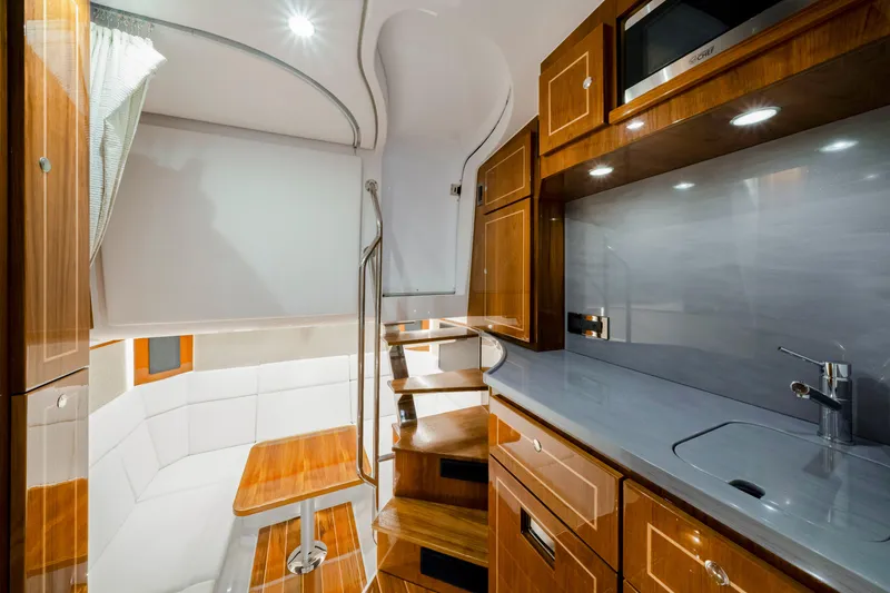 Slide: The Image of Luxurious interior of 2027 HCB 56 Suenos yacht with modern kitchen and seating area. - 64