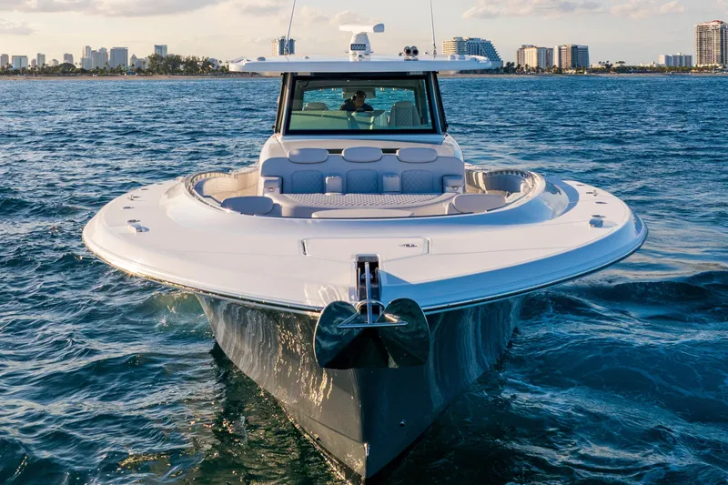 Slide: The Image of 2027 HCB 56 Suenos luxury yacht cruising on open water near city skyline. - 9