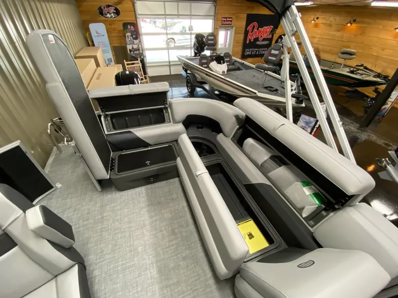 Slide: The Image of Interior of 2026 Sun Tracker Party Barge 20 DLX with seating and storage. - 4
