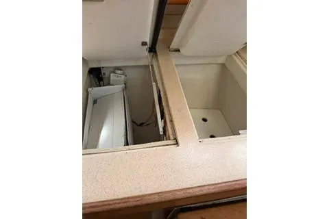 Slide: The Image of 2003 Morgan/Catalina 381 CC interior storage compartments with open lids. - 11