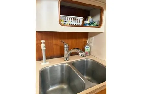 Slide: The Image of 2003 Morgan/Catalina 381 CC kitchen sink with dual basins and storage shelf. - 13