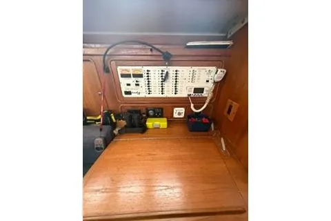 Slide: The Image of Control panel inside 2003 Morgan/Catalina 381 CC boat, featuring wooden interior and electrical switches. - 15