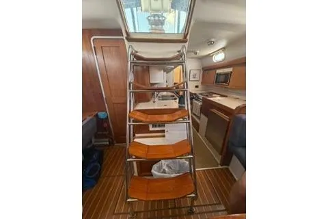 Slide: The Image of Interior view of 2003 Morgan/Catalina 381 CC sailboat with wooden steps and modern kitchen. - 16