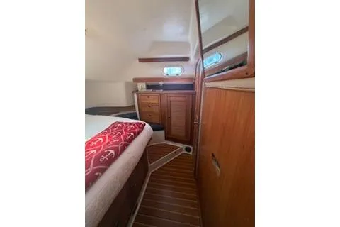 Slide: The Image of Interior of 2003 Morgan/Catalina 381 CC yacht with wooden cabinetry and nautical decor. - 2