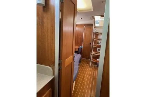 Slide: The Image of Interior of 2003 Morgan/Catalina 381 CC yacht with wooden finishes and cozy seating. - 20