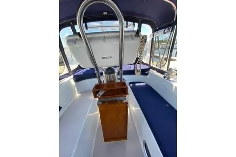 Slide: The Image of 2003 Morgan/Catalina 381 CC sailboat cockpit with blue seating and wooden helm. - 22