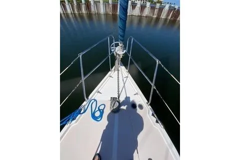 Slide: The Image of Bow view of 2003 Morgan/Catalina 381 CC sailboat with blue rope and calm water. - 25