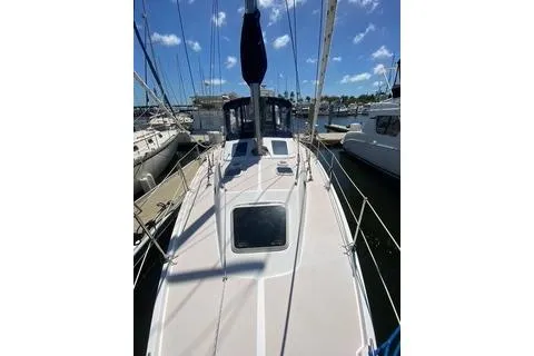 Slide: The Image of 2003 Morgan/Catalina 381 CC sailboat docked at marina under blue sky. - 27