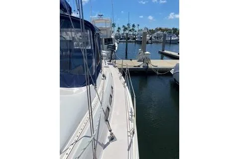 Slide: The Image of 2003 Morgan/Catalina 381 CC yacht docked at a marina under a clear blue sky. - 29