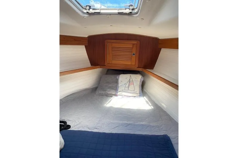 Slide: The Image of Cozy cabin interior of 2003 Morgan/Catalina 381 CC sailboat with bedding and wooden accents. - 31