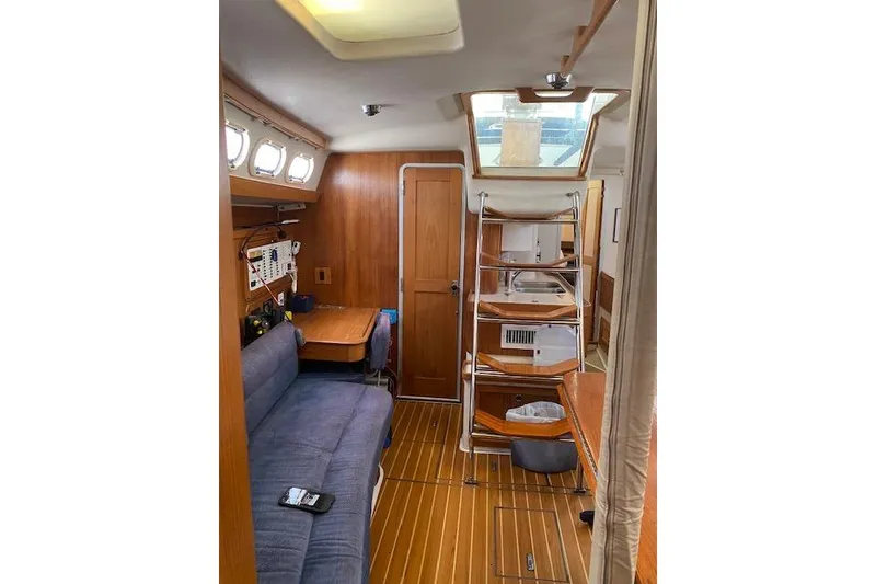 Slide: The Image of Interior of 2003 Morgan/Catalina 381 CC sailboat with wooden furnishings and seating area. - 32