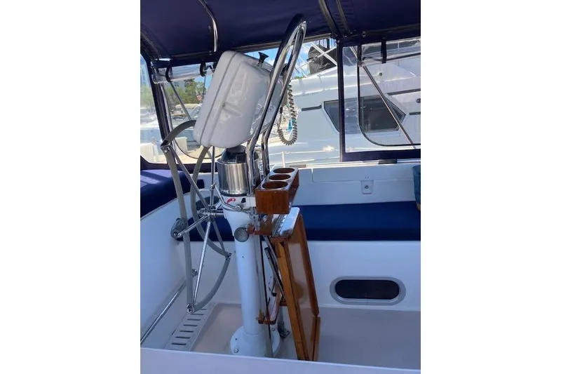 Slide: The Image of Cockpit of 2003 Morgan/Catalina 381 CC sailboat with steering wheel and navigation equipment. - 41