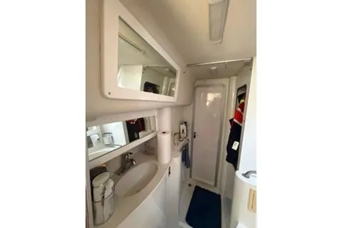 Slide: The Image of 2003 Morgan/Catalina 381 CC yacht bathroom with sink, mirror, and storage. - 5
