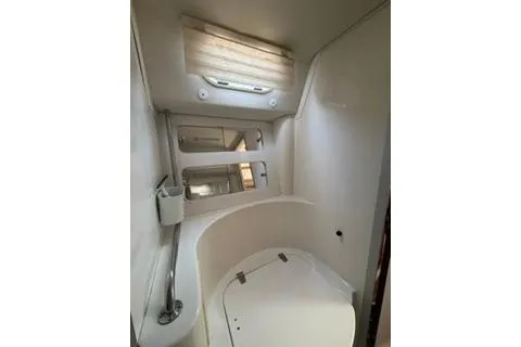 Slide: The Image of Interior of 2003 Morgan/Catalina 381 CC boat, featuring compact bathroom with window and mirrors. - 7