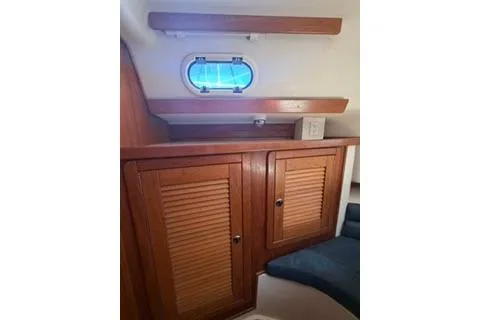 Slide: The Image of Interior of 2003 Morgan/Catalina 381 CC yacht with wooden cabinets and porthole. - 8