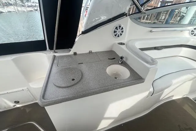 Slide: The Image of 2007 Rinker 280 Express Cruiser interior with sink and countertop, featuring modern design elements. - 11