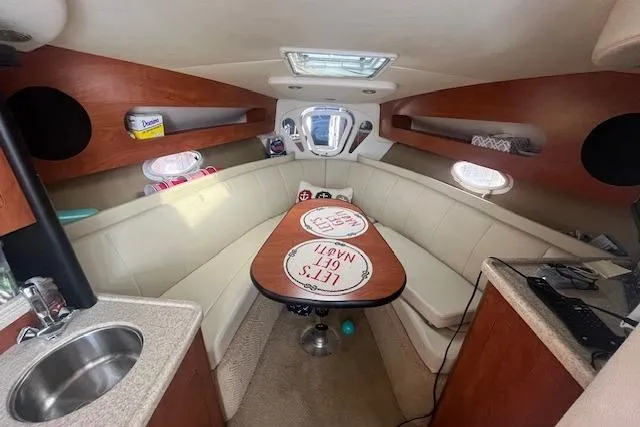 Slide: The Image of Interior of 2007 Rinker 280 Express Cruiser with cozy seating and compact kitchenette. - 15