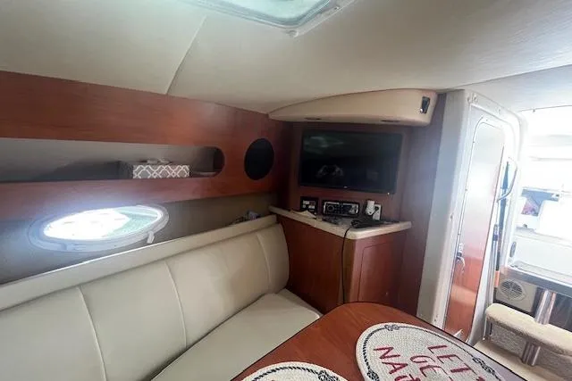 Slide: The Image of Interior of 2007 Rinker 280 Express Cruiser with seating, TV, and porthole window. - 16