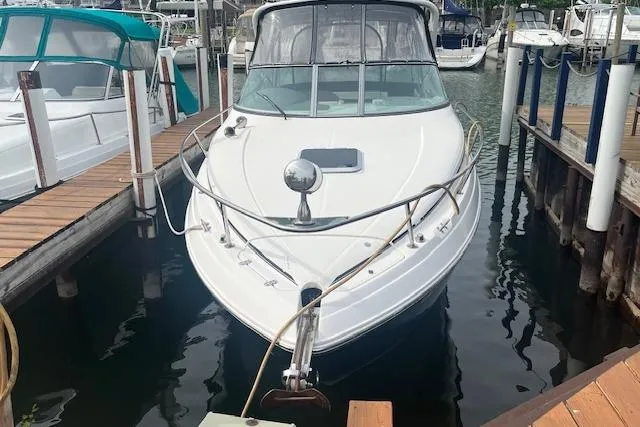 Slide: The Image of 2007 Rinker 280 Express Cruiser docked at marina, front view. - 2