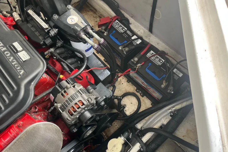 Slide: The Image of Engine compartment of a 2007 Rinker 280 Express Cruiser with visible batteries and wiring. - 25