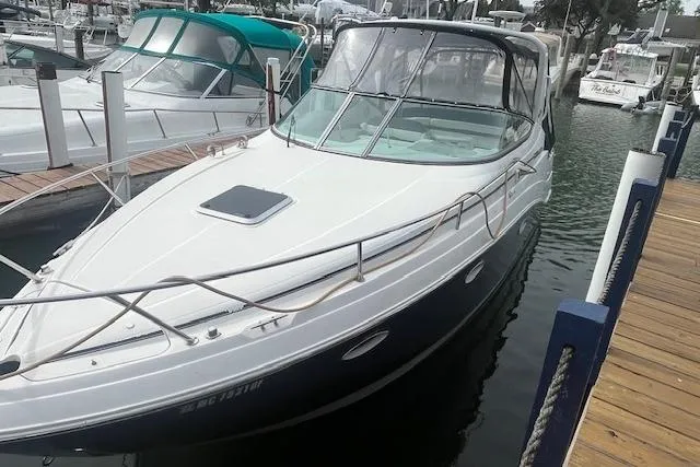 Slide: The Image of 2007 Rinker 280 Express Cruiser docked at a marina. - 3