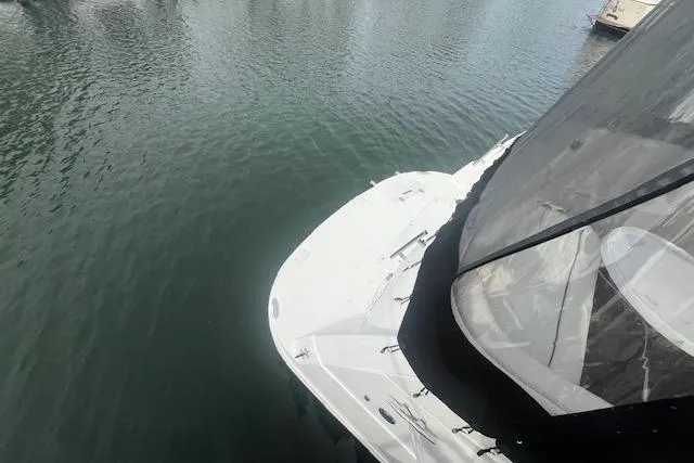 Slide: The Image of 2007 Rinker 280 Express Cruiser docked on calm water. - 6