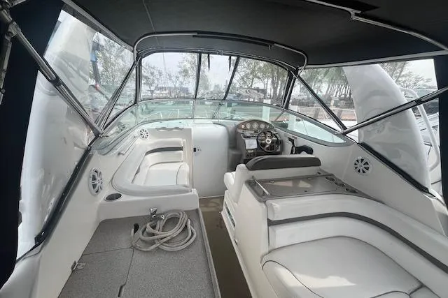 Slide: The Image of 2007 Rinker 280 Express Cruiser interior with helm, seating, and canopy. - 7