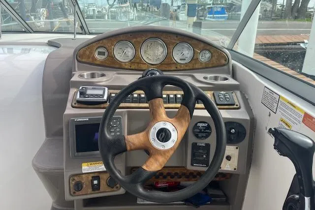 Slide: The Image of Steering console of a 2007 Rinker 280 Express Cruiser with gauges and controls. - 9