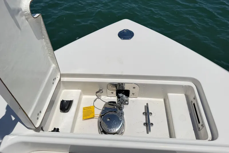 Slide: The Image of Anchor compartment of 2021 Sailfish 290 CC boat with open hatch. - 16