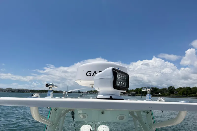 Slide: The Image of 2021 Sailfish 290 CC boat with radar and spotlight on a sunny day. - 23