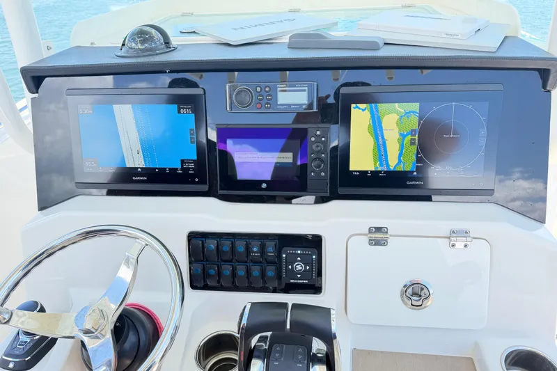 Slide: The Image of Dashboard of 2021 Sailfish 290 CC boat with Garmin navigation displays. - 26