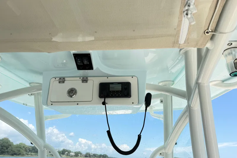 Slide: The Image of Interior view of 2021 Sailfish 290 CC boat's control panel under a clear sky. - 30