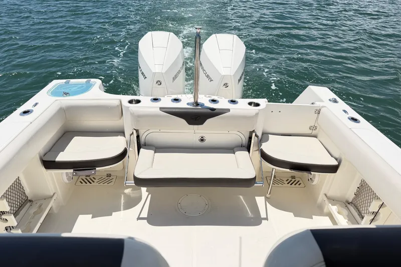 Slide: The Image of 2021 Sailfish 290 CC boat interior with seating and twin Mercury engines. - 33