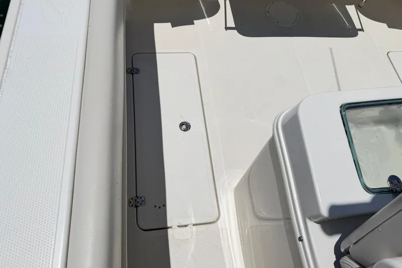 Slide: The Image of 2021 Sailfish 290 CC boat deck with storage compartment and seating area. - 34
