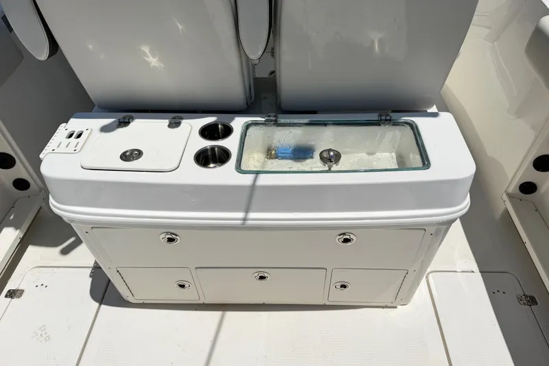 Slide: The Image of Sailfish 290 CC 2021 boat console with storage compartments and livewell. - 35