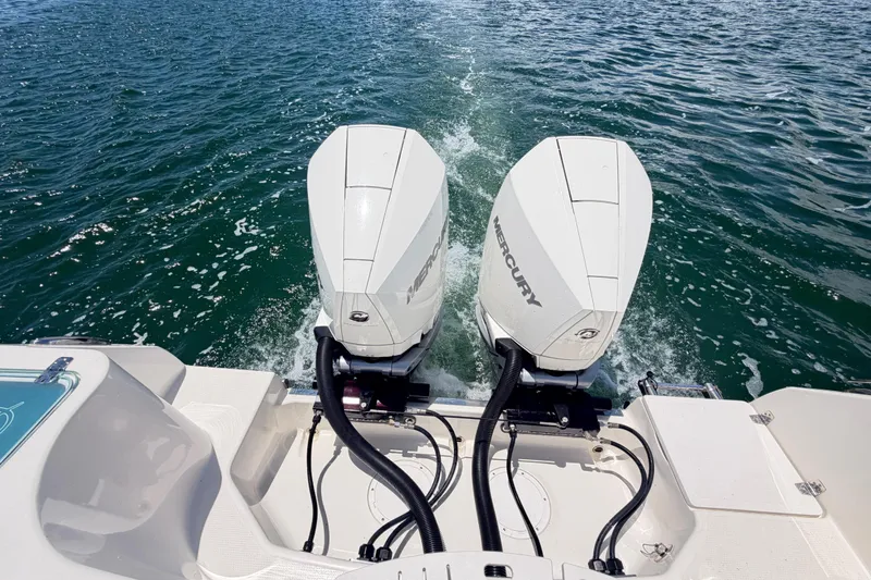Slide: The Image of Twin Mercury outboard engines on a 2021 Sailfish 290 CC boat cruising on water. - 37