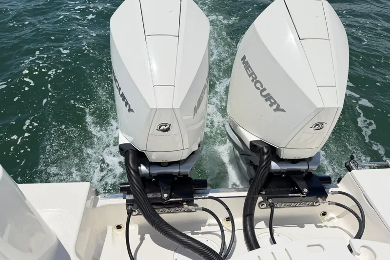 Slide: The Image of Twin Mercury outboard engines on a 2021 Sailfish 290 CC boat in water. - 40