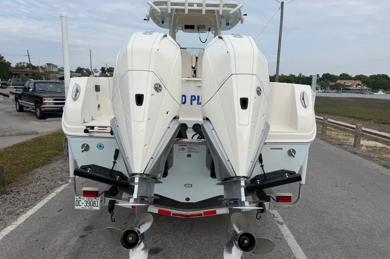 Slide: The Image of 2021 Sailfish 290 CC boat with dual outboard engines on a trailer. - 47