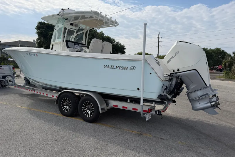 Slide: The Image of 2021 Sailfish 290 CC boat on trailer with Mercury outboard motor. - 48