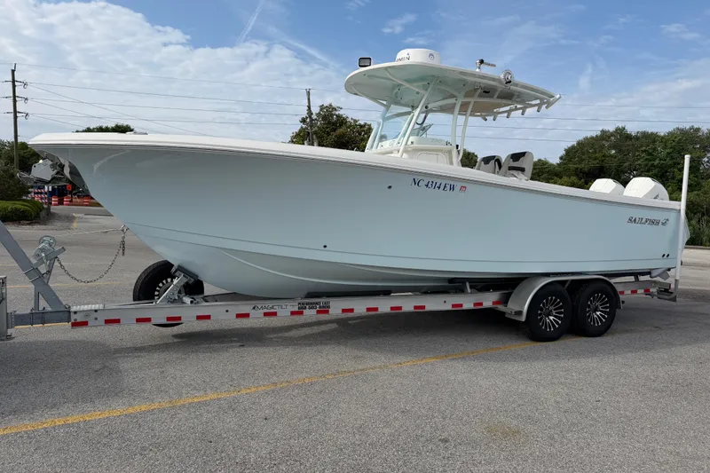 Slide: The Image of 2021 Sailfish 290 CC boat on trailer in parking lot, side view. - 49