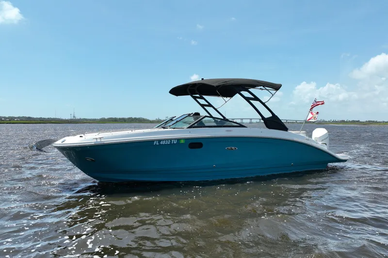 Slide: The Image of 2024 Sea Ray SDX 270 Outboard boat on water, blue hull, black canopy. - 1