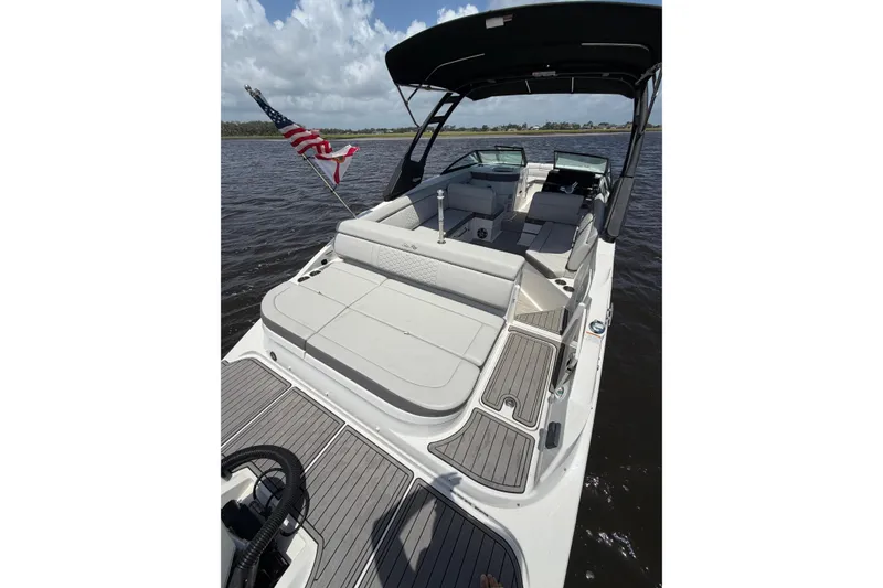 Slide: The Image of 2024 Sea Ray SDX 270 Outboard boat with spacious seating and American flag. - 10