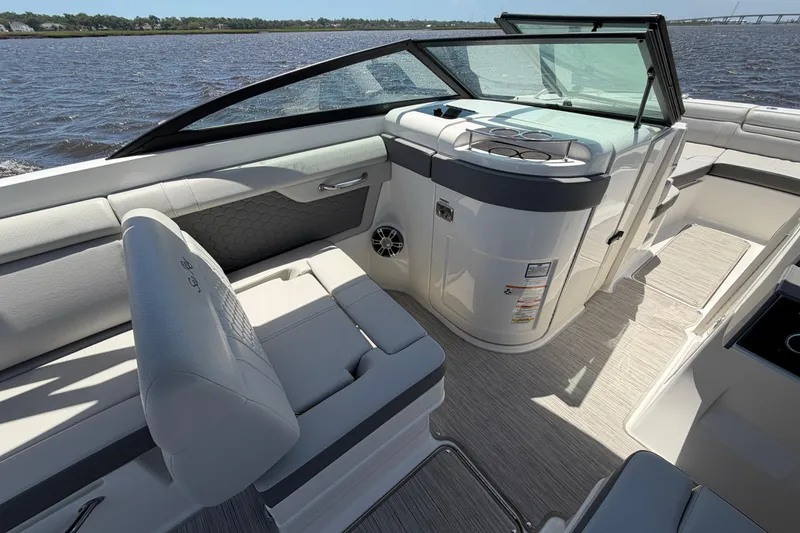 Slide: The Image of 2024 Sea Ray SDX 270 Outboard boat interior with seating and helm, on a sunny day. - 15