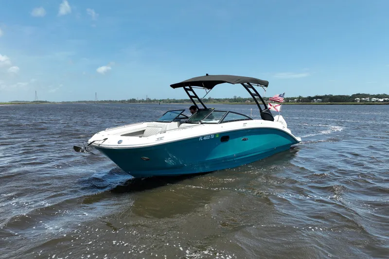 Slide: The Image of 2024 Sea Ray SDX 270 Outboard boat cruising on a sunny day with an American flag. - 3