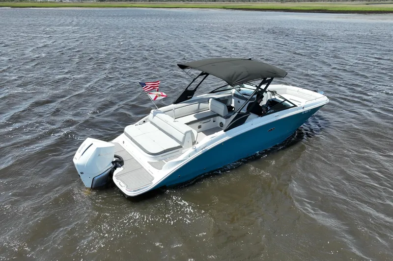 Slide: The Image of 2024 Sea Ray SDX 270 Outboard boat on water, featuring sleek design and American flag. - 6