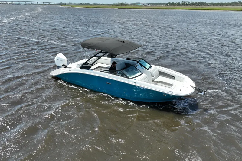 Slide: The Image of 2024 Sea Ray SDX 270 Outboard cruising on open water, featuring sleek design and spacious seating. - 7