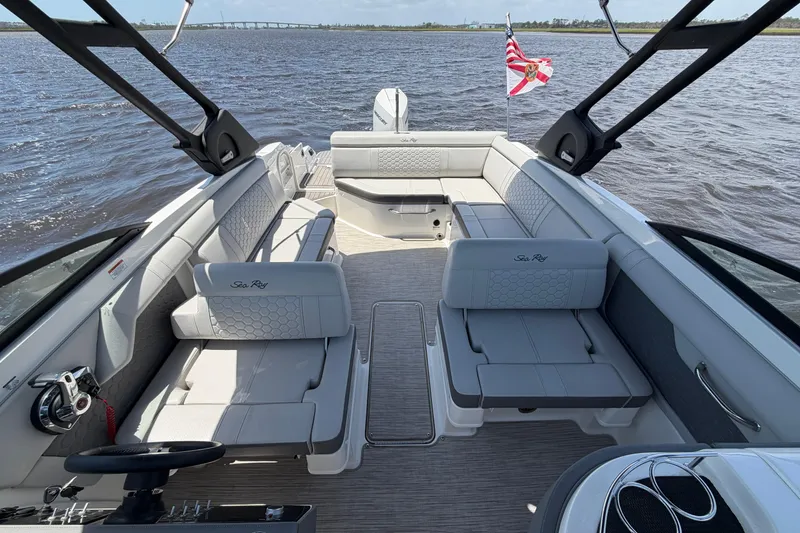 Slide: The Image of 2024 Sea Ray SDX 270 Outboard boat interior with spacious seating on the water. - 9